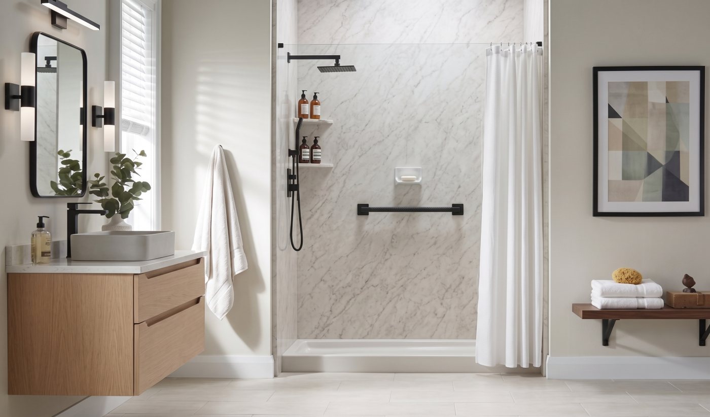 Modern bathroom with a walk-in shower, grab bar, and light stone-look walls